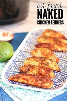 air fried chicken tenders on a blue and white plate with lime next to it