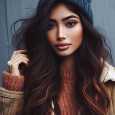 Gorgeous woman with long wavy hair and a beanie.