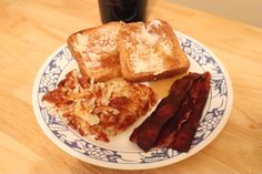 a plate with toast, bacon and cheese on it