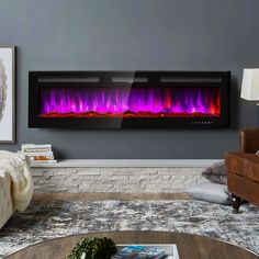 a living room with a couch, chair and large wall mounted fire place in it