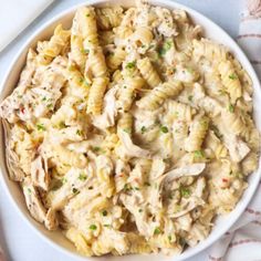 a white bowl filled with pasta and chicken