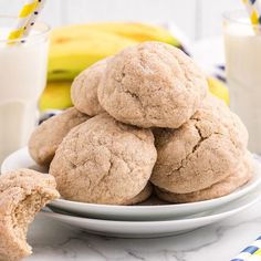 soft banana cookies on a plate with milk and bananas in the background