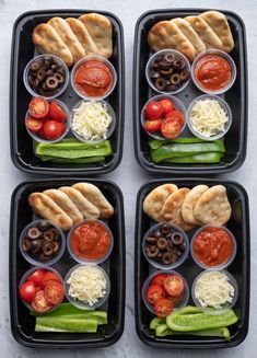 four plastic trays filled with different types of food