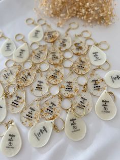 a table topped with lots of white and gold necklaces on top of each other