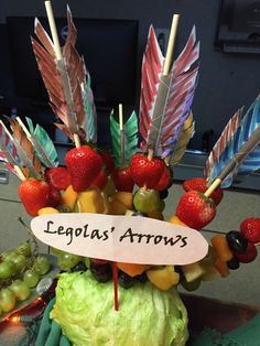 an arrangement of fruits and vegetables with the name legola's arrows written on it