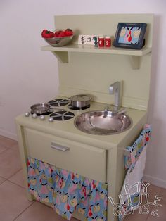 an old fashioned kitchen with a sink and stove in the corner, next to a pot holder