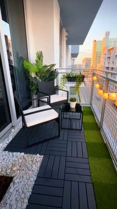 a balcony with two chairs and plants on the grass next to each other, along with an artificial lawn