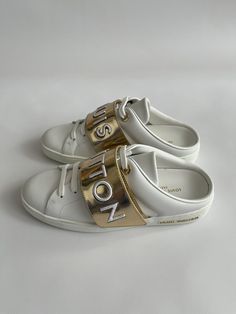 Louis Vuitton Women's Stellar Open Back White Leather Sneakers Sz 35  | eBay Luxury Leather Sneakers With Metallic Logo, Designer Sneakers With Removable Insole And White Sole, Designer Sneakers With Removable Insole, Luxury Sneakers With Leather Sole And Flat Heel, Gold Leather Slip-on Sneakers, Luxury Leather Sneakers With Flat Heel, Luxury Flat Heel Leather Sneakers, Spring Leather Sneakers With Logo, Designer Streetwear Sneakers With Removable Insole