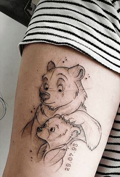 a woman with a bear and dog tattoo on her leg