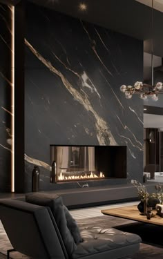 a modern living room with a fireplace in the center and black marble on the walls