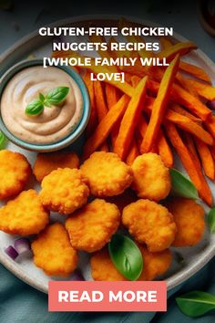 a plate filled with fried chicken nuggets and french fries next to a bowl of dip