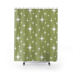 a green shower curtain with white stars on the bottom and bottom, in front of a white background