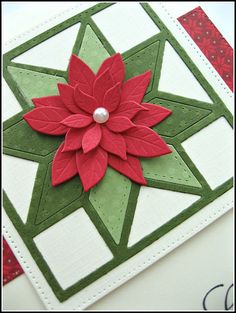 a close up of a christmas card with a poinsettia flower on it