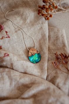 "We've captured the dancing sky! Inside this opal wood necklace you can find a picturesque landscape with tiny mountains, set in front of a colorful display of iridescent green blue colors. The opalescent effect looks almost like real northern lights. The iridescent necklace is a complex fusion of three materials. It is made from rare burl wood, with protruding natural formed growths, crystal clear resin and synthetic opal. This nature necklace makes for a great birthday gift for any nature lovi Handmade Iridescent Opal Necklaces, Iridescent Opal Necklace For Gift, Iridescent Opal Necklace Perfect For Gifts, Iridescent Opal Necklaces For Gift, Iridescent Teardrop Necklace For Gifts, Artisan Opal Necklaces As Gifts, Artisan Opal Necklaces For Gifts, Five Year Anniversary Gift, Iridescent Necklace