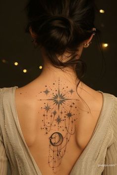 the back of a woman's neck with stars and moon tattoos on her chest