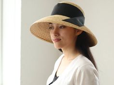 "I just adore classic movie stars wearing their hats so elegantly. This Casablanca style hat, \" Holly\", is inspired by those classic movies, and also added modernity for today. The wide brim is nicely curved to the end, covers perfectly your face from sunshine. Material is natural, narrow good quality straw, which you hardly find in mass products nowadays. Please chose ribbon colour black, white, beige and grey. I attached the ribbon to the side by sewing. If you wish to show in the front or b Elegant Visor Boater Hat For Vacation, Elegant Boater Hat With Visor For Vacation, Elegant Straw Visor Hat, Elegant Adjustable Panama Visor Hat, Elegant Adjustable Panama Hat With Visor, Elegant Boater Hat With Visor For Spring, Elegant Spring Boater Hat With Visor, Elegant Visor Sun Hat For Kentucky Derby, Elegant Summer Panama Visor Hat