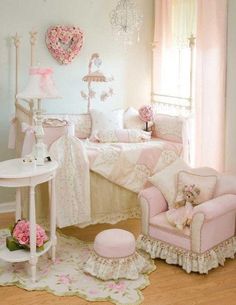 a bedroom with pink furniture and decor on the walls