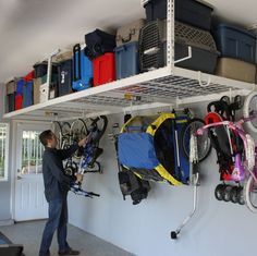 a man is standing in front of a rack with luggage and backpacks on it