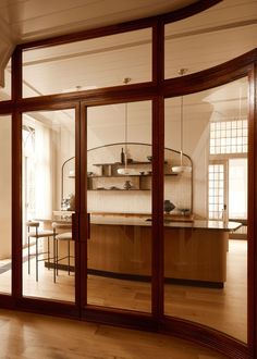 a kitchen with wooden floors and large glass doors