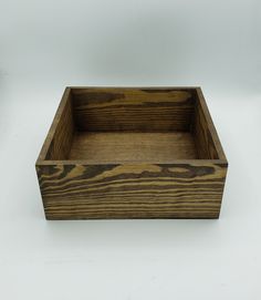 a wooden box sitting on top of a white table