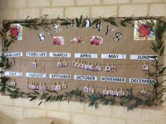 a bulletin board with calendars and pictures hanging on it's sides in front of a brick wall