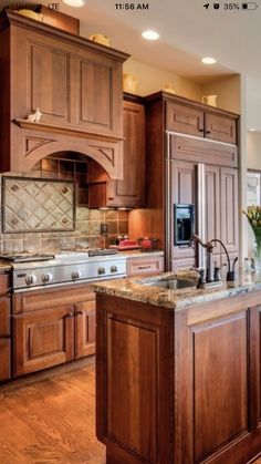 a large kitchen with wooden cabinets and granite counter tops