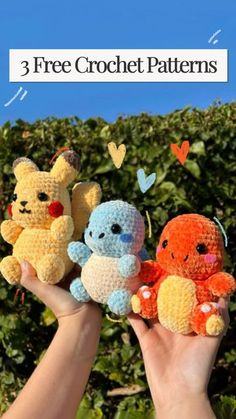 three crocheted stuffed animals are held up in front of some bushes with hearts