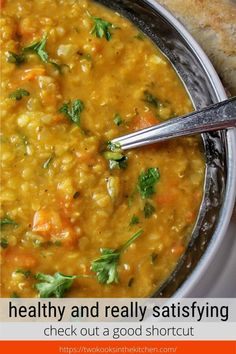 a bowl of soup with bread on the side