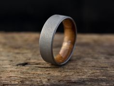 a wedding band with a wooden inlay