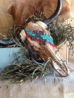 an animal's head is adorned with beaded beads and other things on display