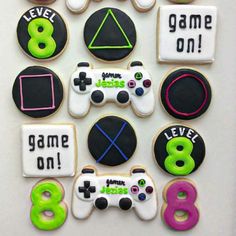 decorated cookies are arranged in the shape of video game controllers and words that spell out games on