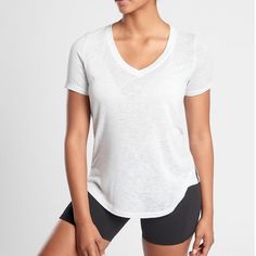 Athleta White Scoop V-Neck Short Sleeve Breezy Tee Top Brand New - Without Hang Tag/ Paper Tag. Material - 55% Modal,45% Polyester Tencel Modal/Polyester Sustainable: Tencel Modal Is A Fiber That Is Produced From European Beechwood Trees Harvested From Sustainable Forests Where 99% Of The Raw Material Comes From Certified Or Controlled Sources Easy Care. Just Throw In The Wash And Dry Without A Second Thought Breathable. Sweat Can Travel Through The Fabric So It Can Evaporate On The Surface Mach Sporty Stretch V-neck Tops, White Scoop Neck Athleisure Top, White Scoop Neck Top Athleisure Style, White Scoop Neck Top For Athleisure, White V-neck Athleisure Top, Casual V-neck Workout Tops, White V-neck Athleisure Activewear, Athleisure Scoop Neck Tops For Light Exercise, Scoop Neck Tops For Light Exercise, Athleisure Style