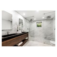 a bathroom with a walk in shower next to a sink