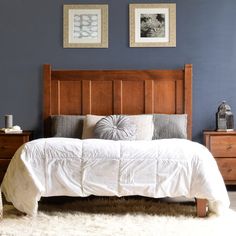 a bed sitting in a bedroom next to two framed pictures on the wall above it