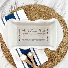 a personalized serving dish with two wooden spoons