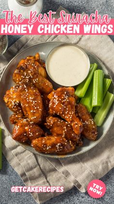 a plate with chicken wings, celery and ranch dressing