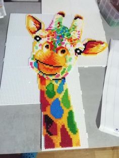 a giraffe made out of legos sitting on top of a table