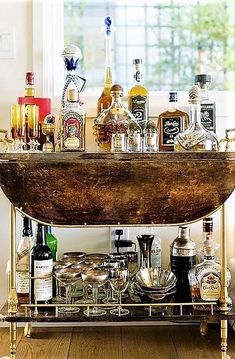 an old fashioned bar cart filled with liquor bottles