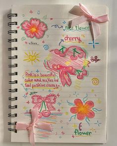 an open notebook with drawings on it and a pink ribbon tied around the page that says, little flowers cherry