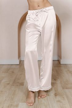 Getting ready the morning of your wedding just got cuter! Our Daybreak Satin Sleep Pants are available in White Pearl Satin for the Bride and all of our satin colors for your wedding party. These pants can be paired with our Daybreak Long Sleeve Shirt, our Sleepover Short Sleeve Shirt, or even our Dolled Up Tanktop. Have your crew be cohesive or have them mix and match with their choosing! For the bride-to-be, you can choose the White Pearl Satin option with a classic White Pearl piping edge or Elegant Straight Leg Wedding Bottoms, White Satin Bottoms For Wedding, White Satin Wedding Bottoms, Elegant Satin Pants For Loungewear, Elegant Wide Leg Bottoms For Pajama Party, Elegant Long Pants For Wedding, Satin Trousers For Loungewear, Satin Colors, Wedding Parties Colors