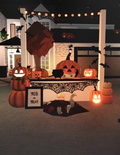 an outdoor halloween display with pumpkins and jack - o'- lanternes on it