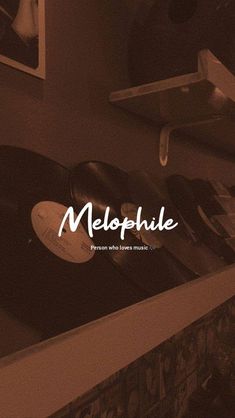 an old record player sitting on top of a shelf next to a wall with the word melopub