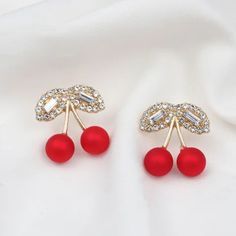 Experience timeless elegance with our A Pearl Of Wisdom Earrings. Hand-crafted with lustrous pearls, these earrings are a perfect accessory for any occasion. Add a touch of sophistication to your wardrobe and elevate your style with these stunning earrings. Elegant Cherry Colored Jewelry For Party, Elegant Red Pearl Earrings For Parties, Elegant Cherry Drop Earrings, Party Cherry Earrings, Elegant Red Bridal Earrings With Pearl Drop, Trendy Pearl Earrings For Party, Stunning Earrings, Elevate Your Style, Timeless Elegance