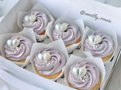 some cupcakes with frosting in a box