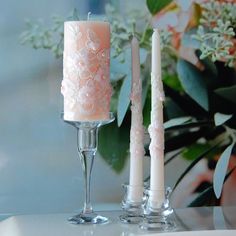 three candles are sitting next to each other on a table