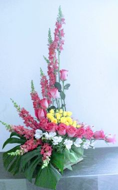 a vase filled with lots of pink and white flowers