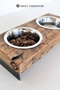 two metal bowls with food in them sitting on a wooden tray that has the word vaut furniture written above it