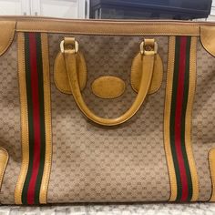 Gucci Vintage Travel Bag. In Beautiful Preloved Vintage Condition. Cloth Stripe On Both Sides. Mustard/Brown Leather. Monogram Pvc Canvas. Some Signs Of Leather Aging On Handles And Corners. Some Sun Tanned Spots On Both Sides. Includes Luggage. Tiny Loose Stich On The Side Of The Bag As Seen In The Pic. A True And Rare Gem. Don't Miss This Beauty! Dimensions: 20.5"W X 13.8"H X 8.7"D Pre-owned Gucci Shoulder Bag For Travel, Pre-owned Brown Gucci Bag, Pre-owned Beige Gucci Bag, Leather Monogram, Gucci Vintage, Rare Gems, Sun Tan, Vintage Travel, Vintage Gucci