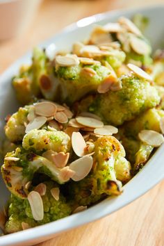 broccoli and almonds are in a white bowl