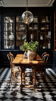 a dining room with black walls and checkered flooring on the floor is shown